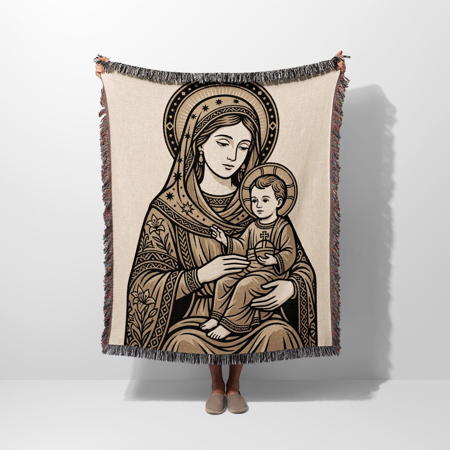 Tapestry blanket featuring Madonna and Child design with fringed edges.