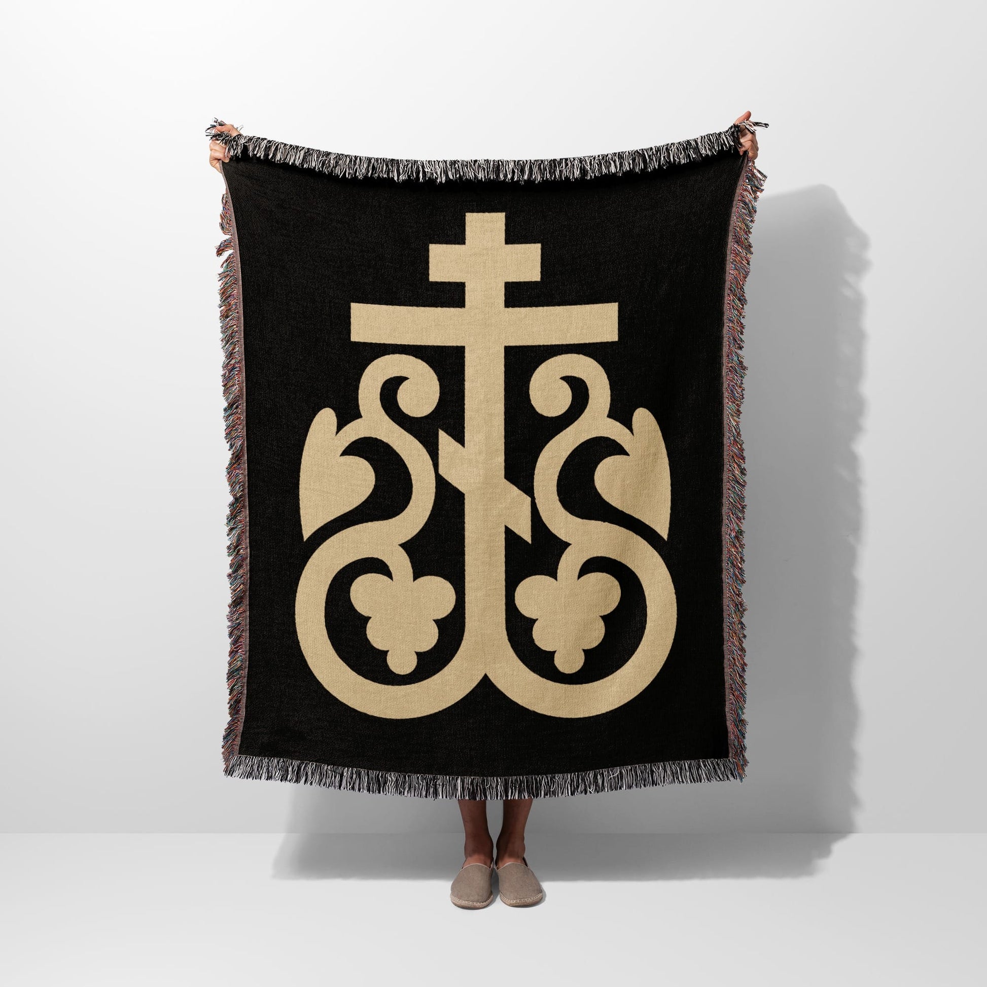 Black woven throw blanket with gold Byzantine cross and decorative flourishes.