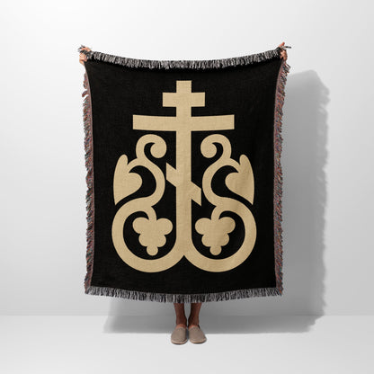 Black woven throw blanket with gold Byzantine cross and decorative flourishes.