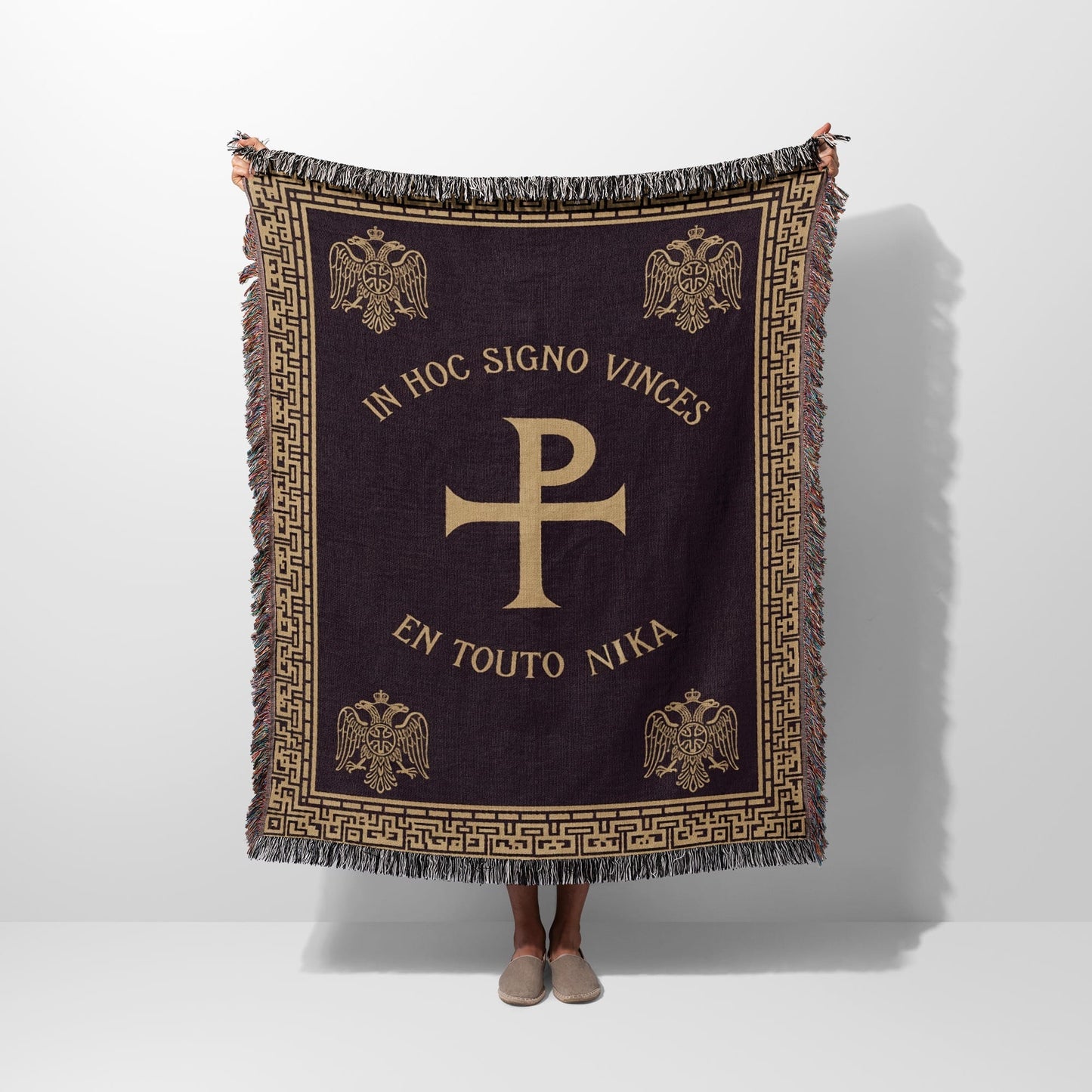 Dark tapestry blanket with Chi Rho symbol and Latin text "In Hoc Signo Vinces".
