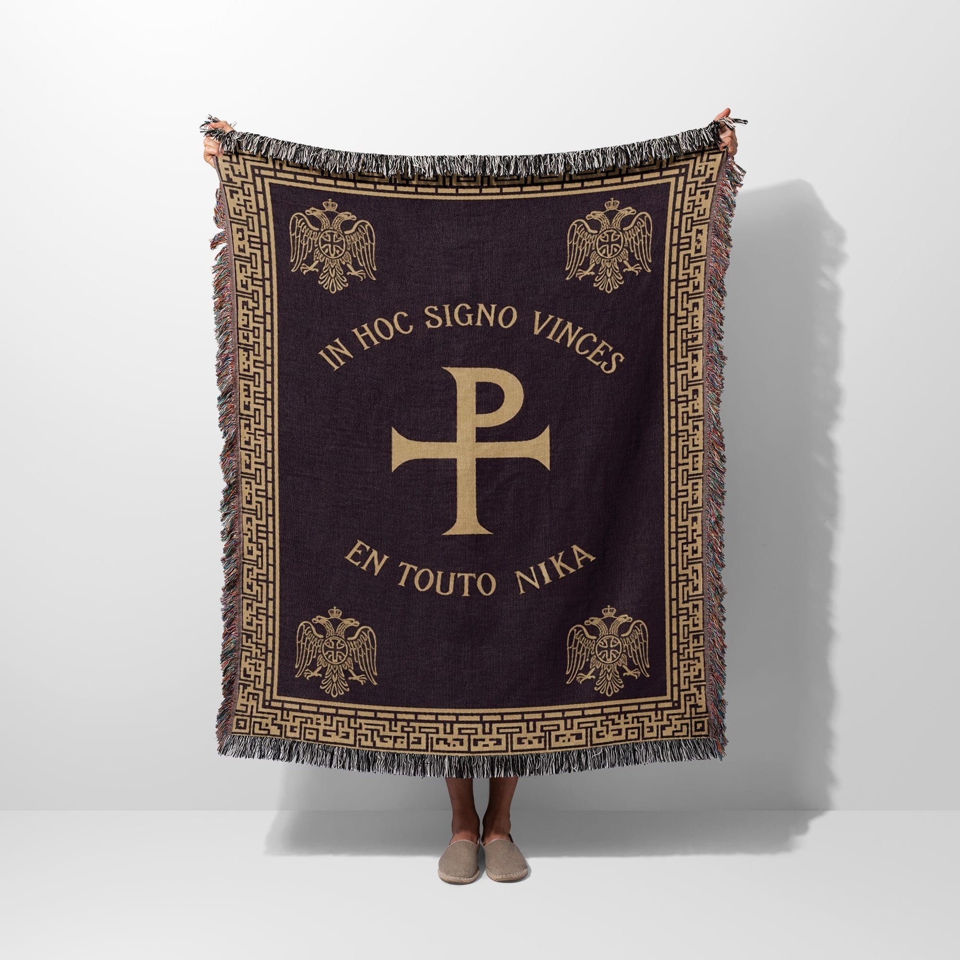 Dark tapestry blanket with Chi Rho symbol and Latin text "In Hoc Signo Vinces".