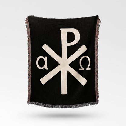 Black throw blanket with beige Chi Rho symbol and alpha omega letters.