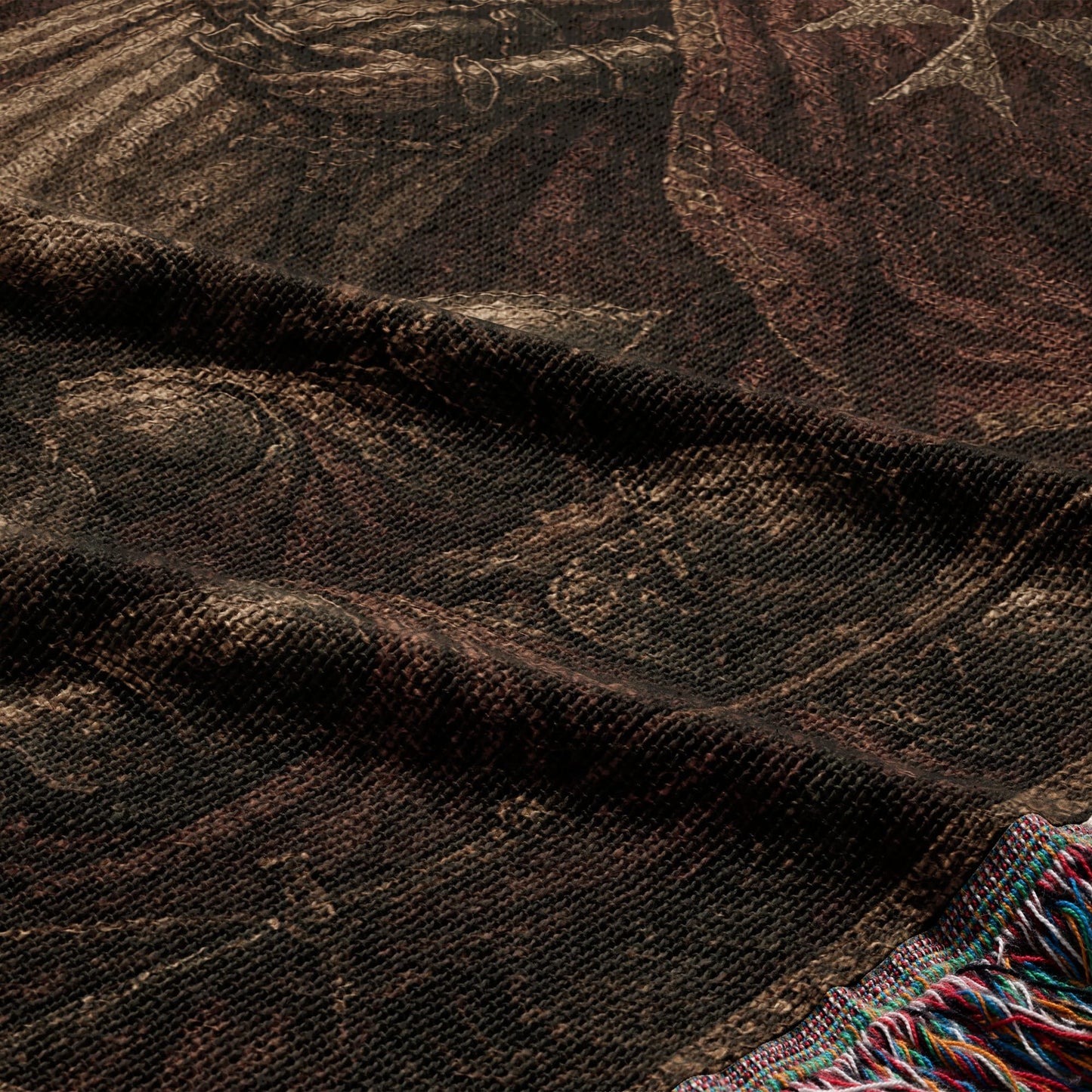 Tapestry with intricate dark brown pattern and colorful fringe detail.