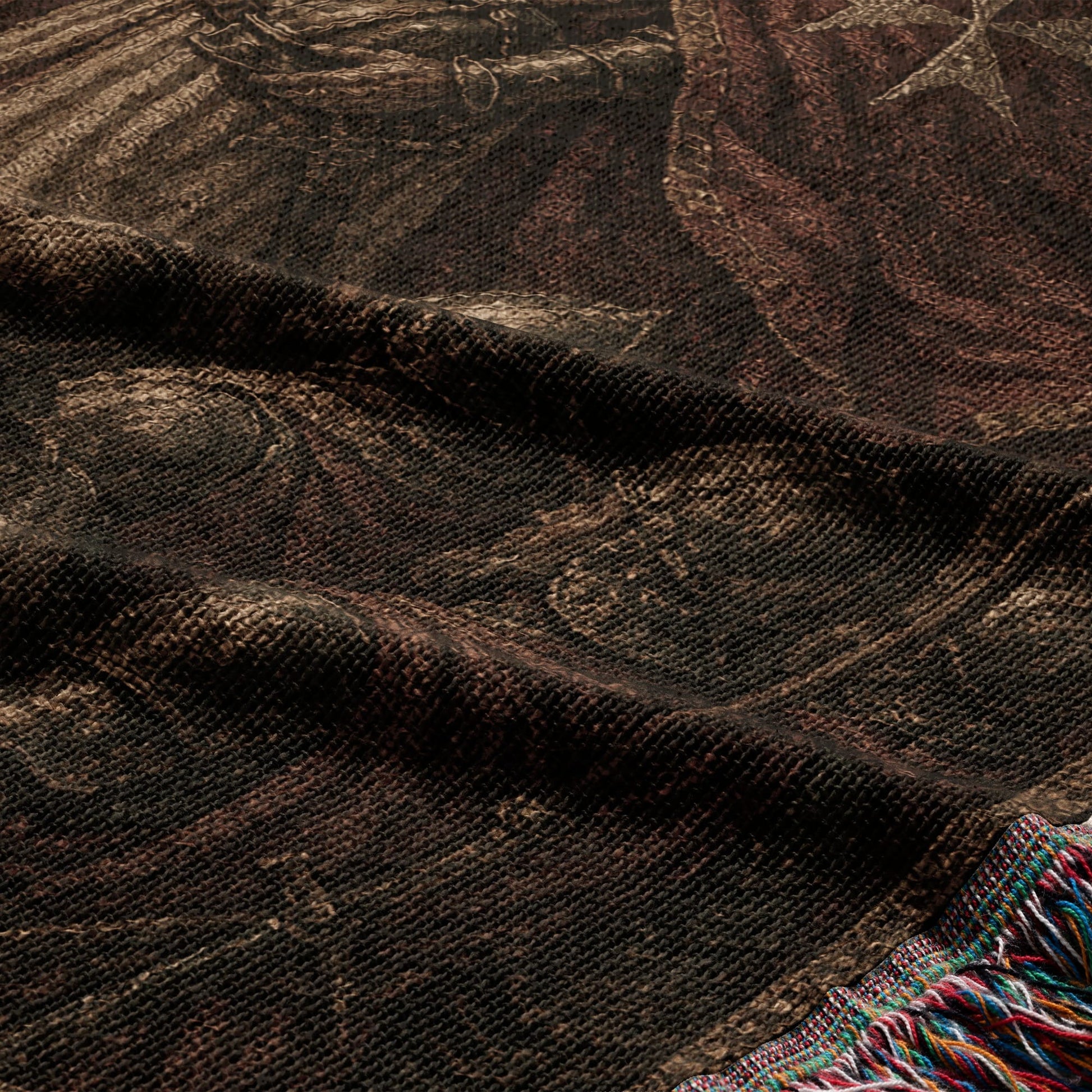 Tapestry with intricate dark brown pattern and colorful fringe detail.
