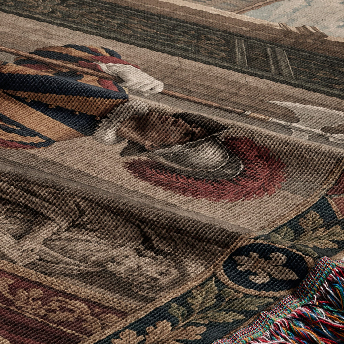 Folded tapestry featuring a medieval knight motif with blue, red, and gold stripes and colorful fringed edges.