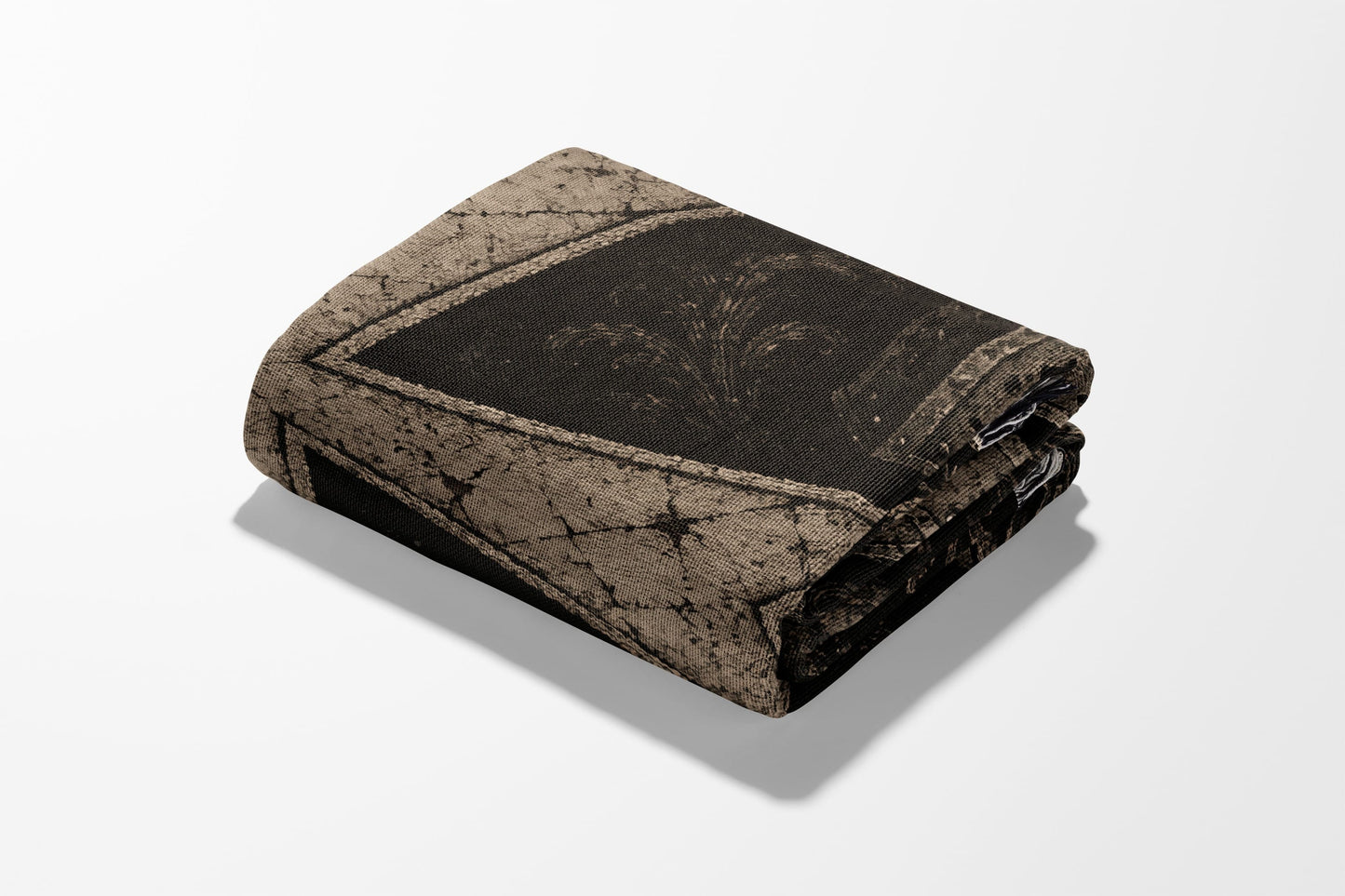 Folded blanket with a dark damask pattern on a white background.