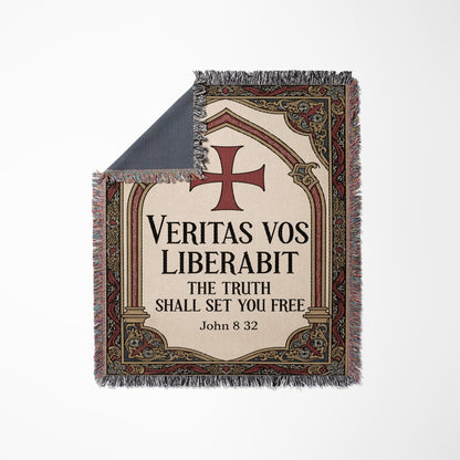 Woven blanket with ornate border and inscription "Veritas Vos Liberabit. The Truth Shall Set You Free. John 8 32."