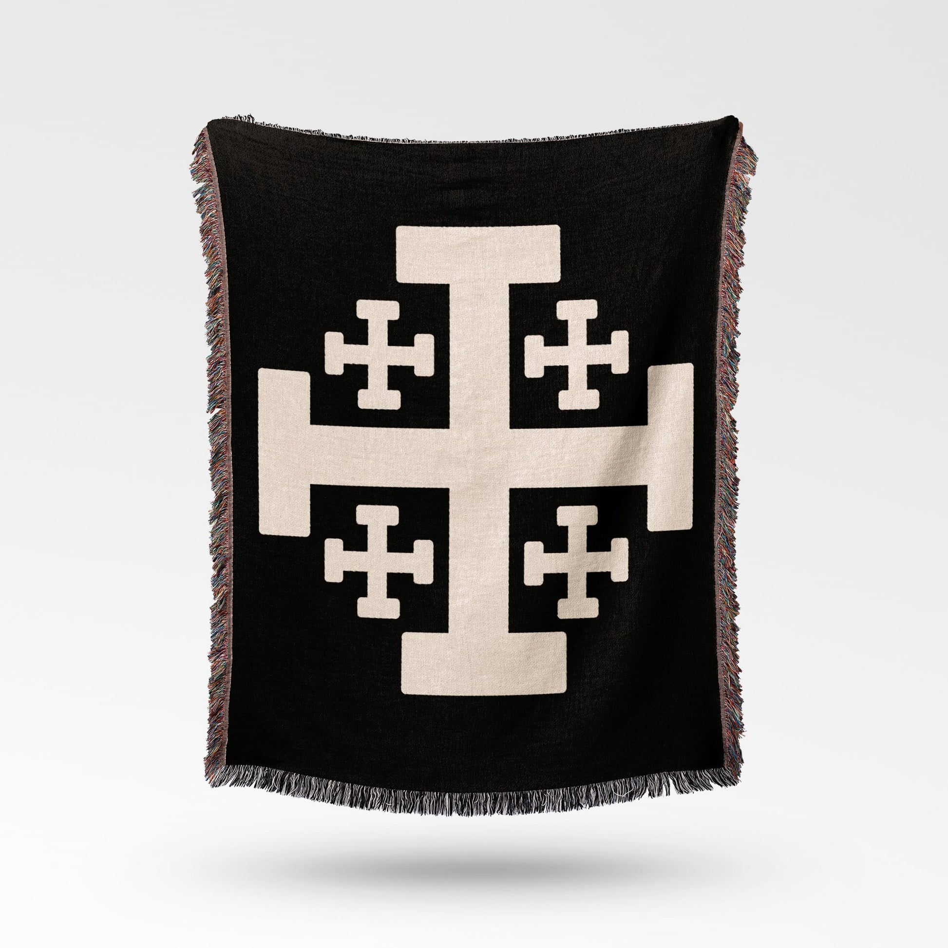 Black throw blanket with a cream Jerusalem cross design.