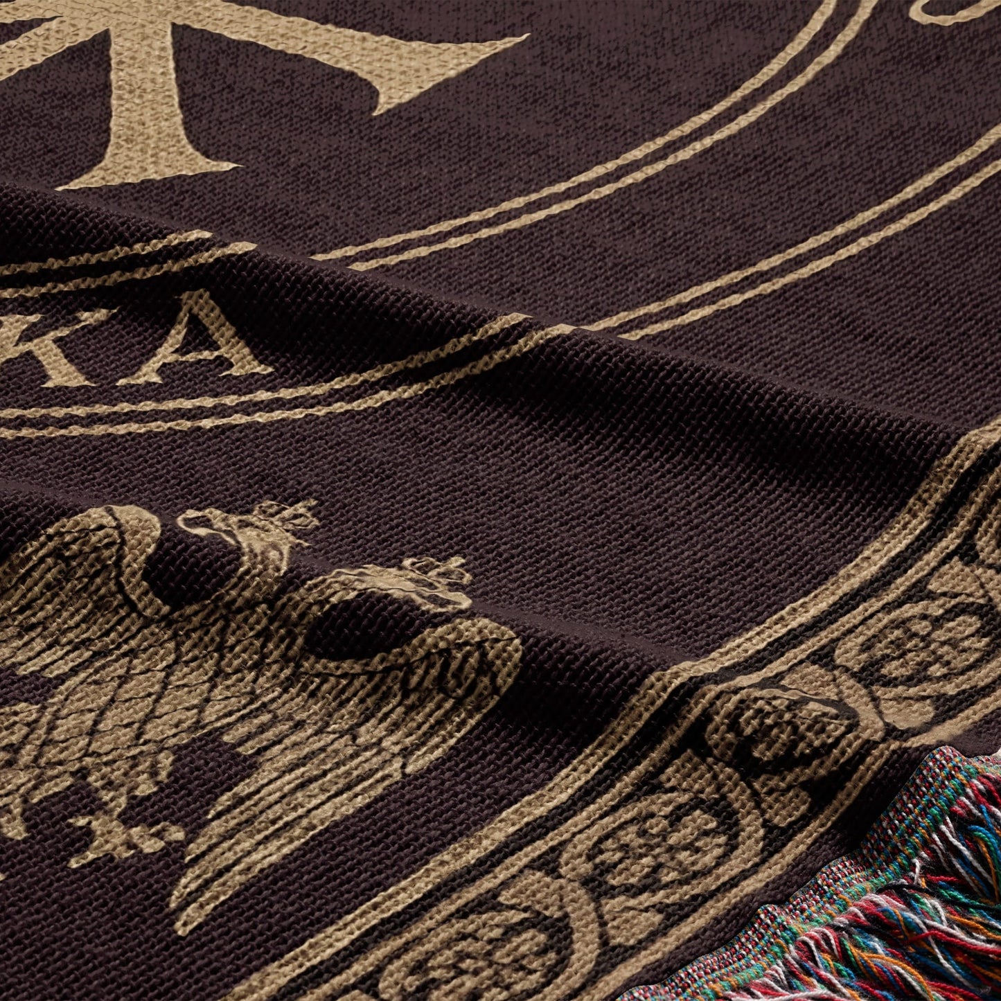 Brown blanket with a gold double-headed eagle crest and decorative border.