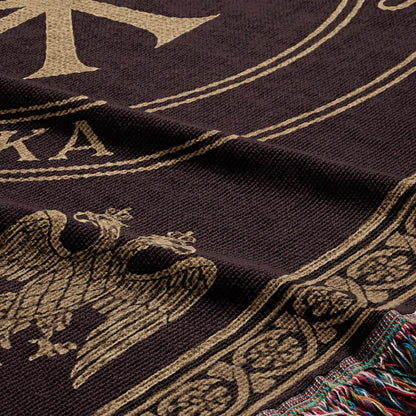 Brown blanket with a gold double-headed eagle crest and decorative border.