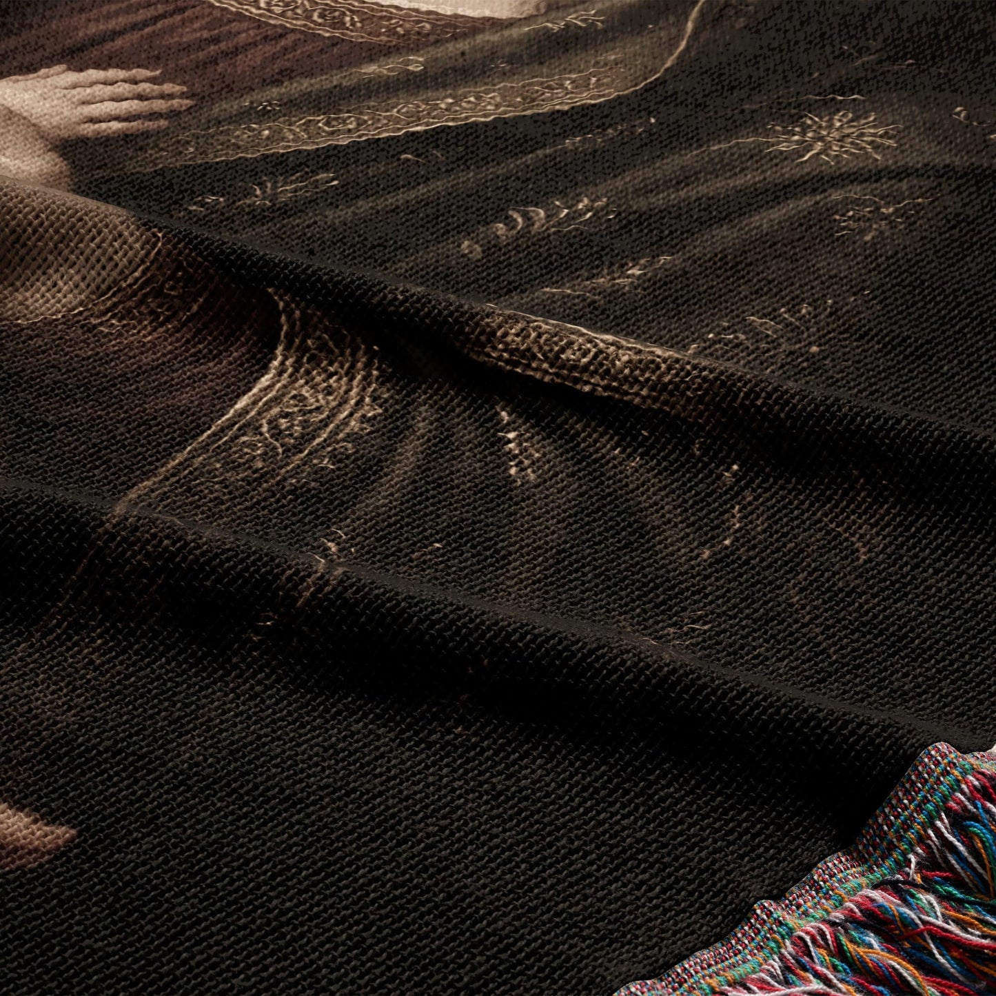 Woven blanket with intricate, dark tapestry depicting a historical figure's face.