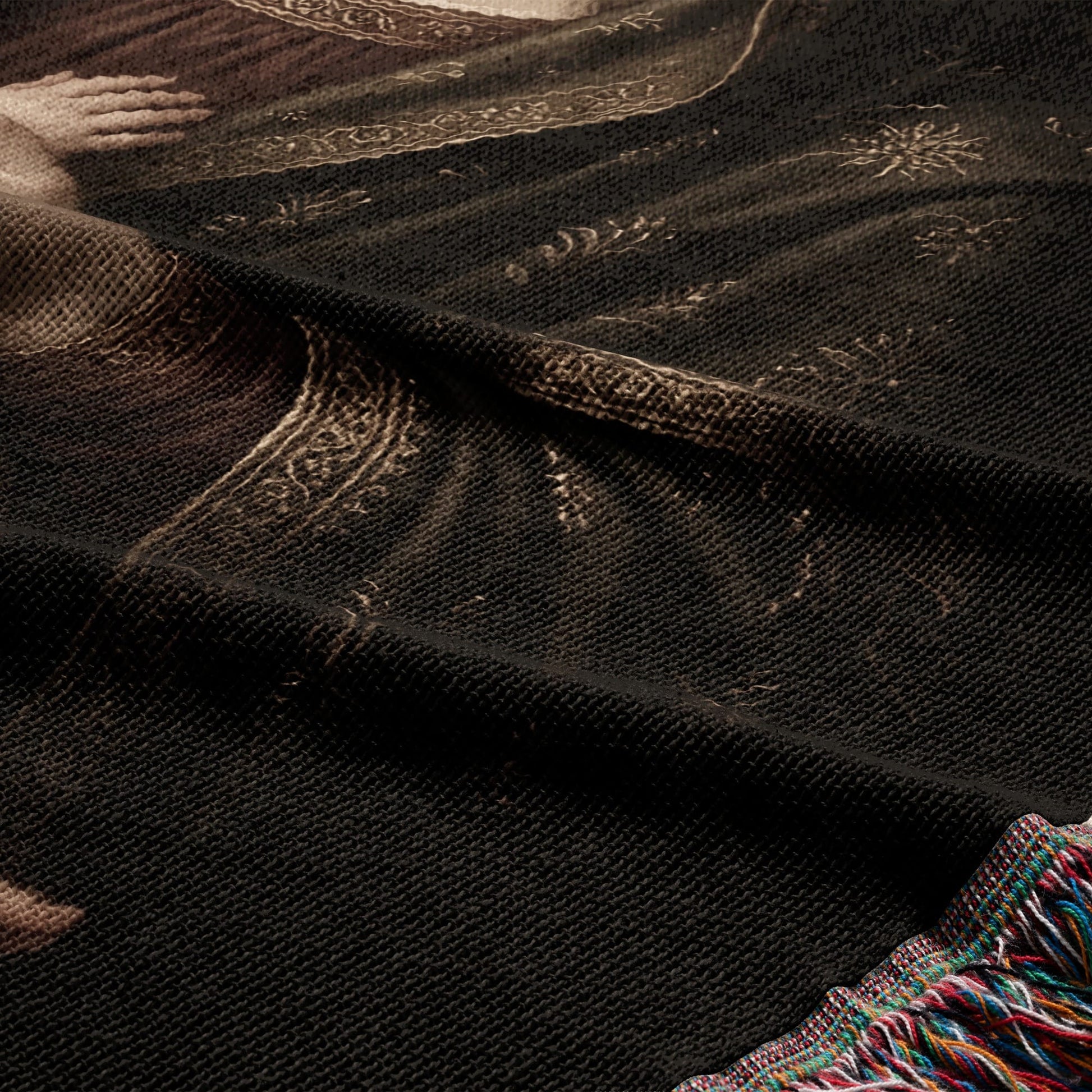 Woven blanket with intricate, dark tapestry depicting a historical figure's face.
