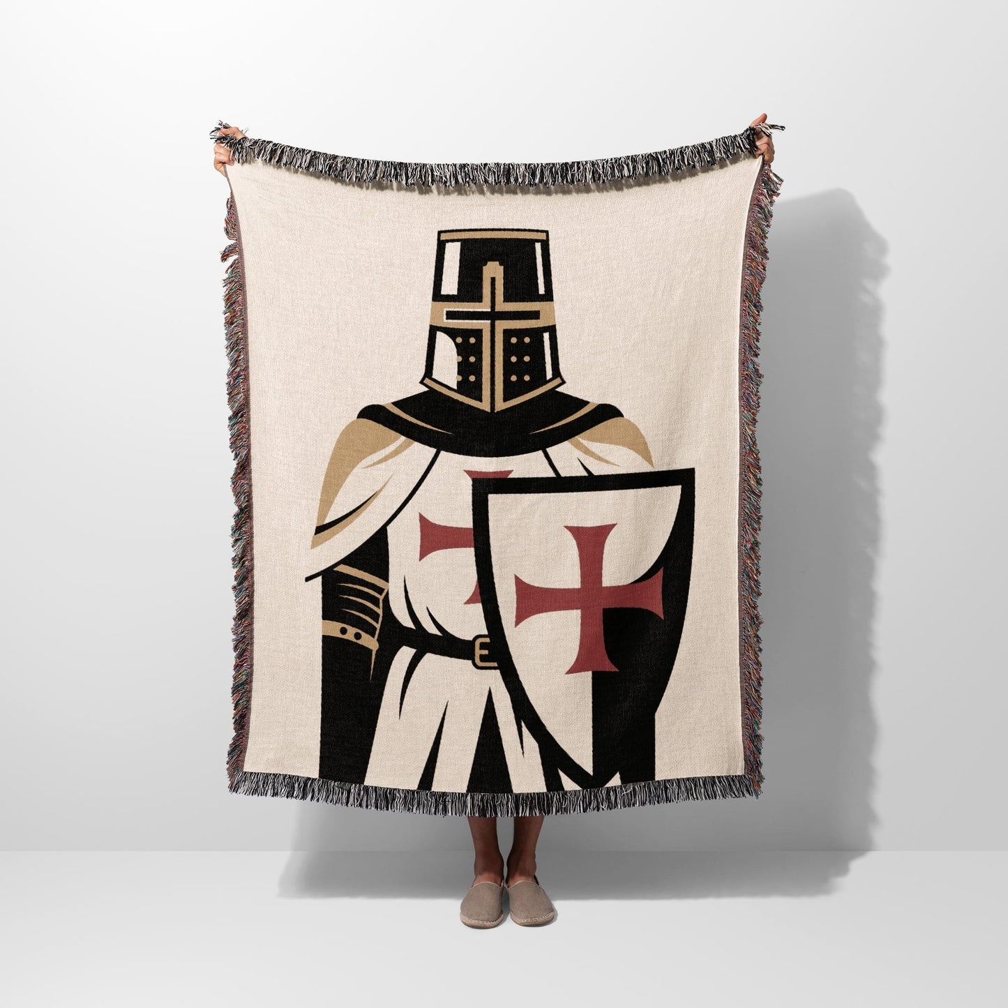 Knight's Templar blanket with cross shield, held up by two hands.