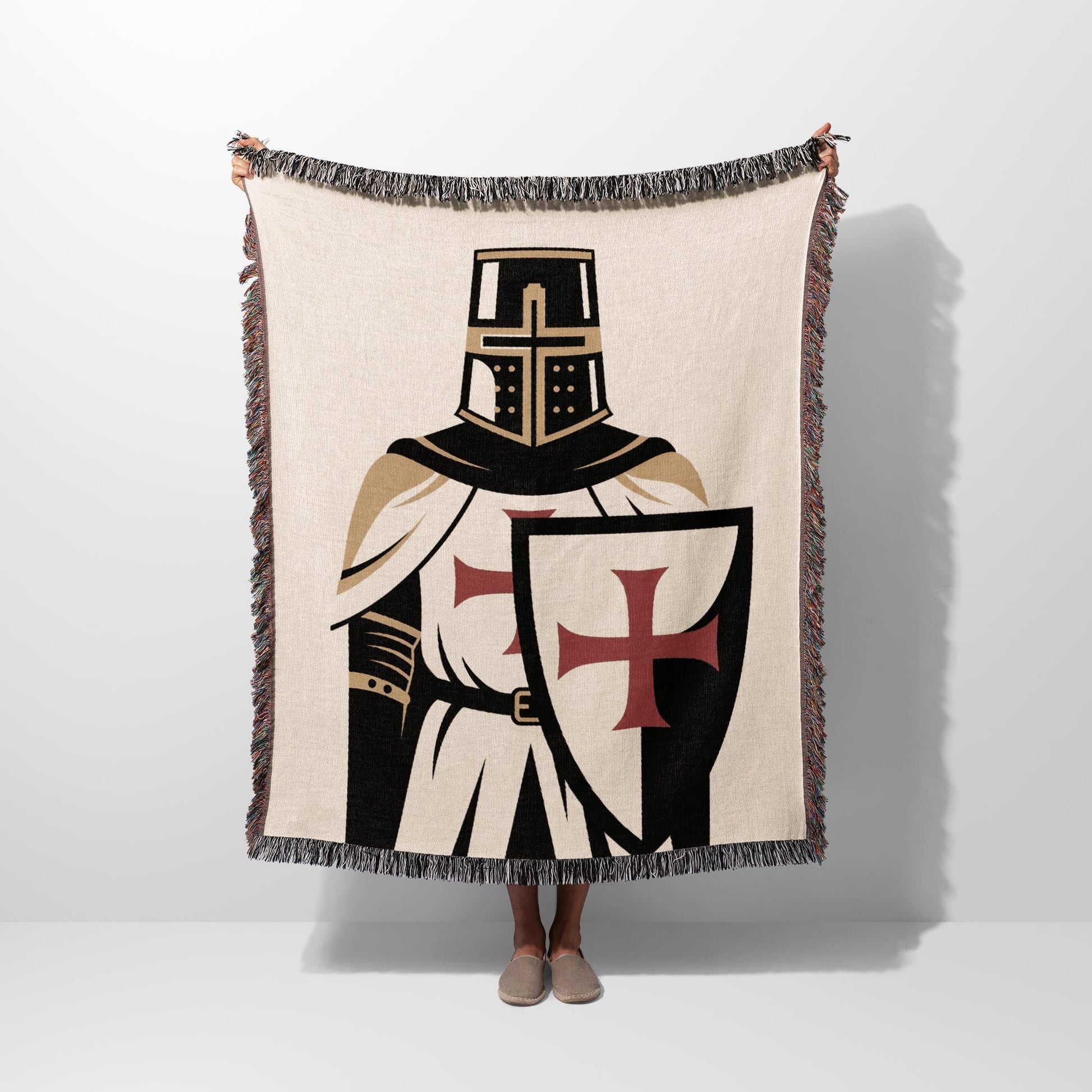 Knight's Templar blanket with cross shield, held up by two hands.