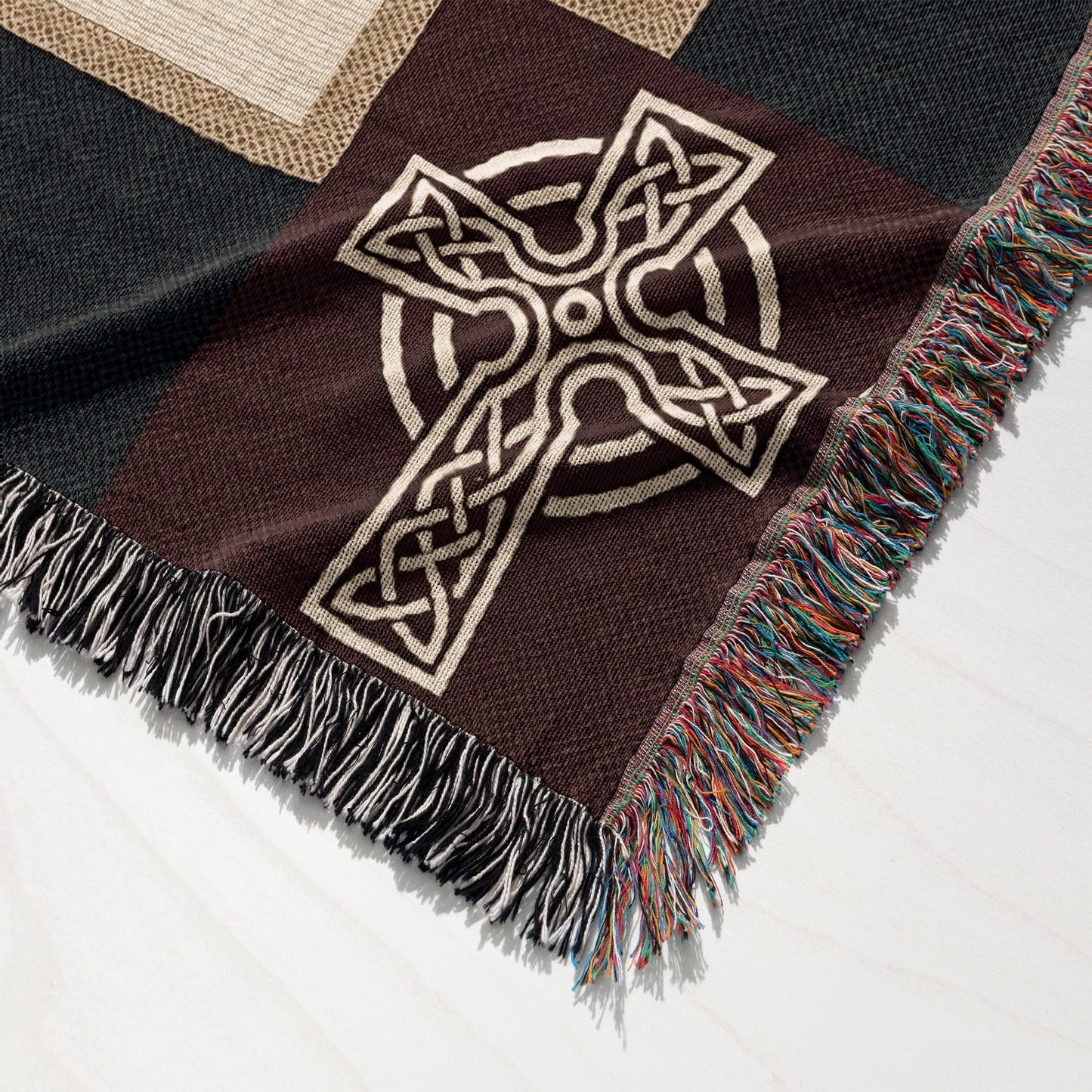 Brown woven throw blanket with a large Celtic cross design and fringed edges.