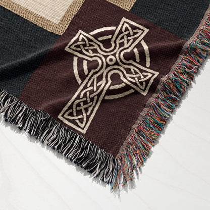 Brown woven throw blanket with a large Celtic cross design and fringed edges.