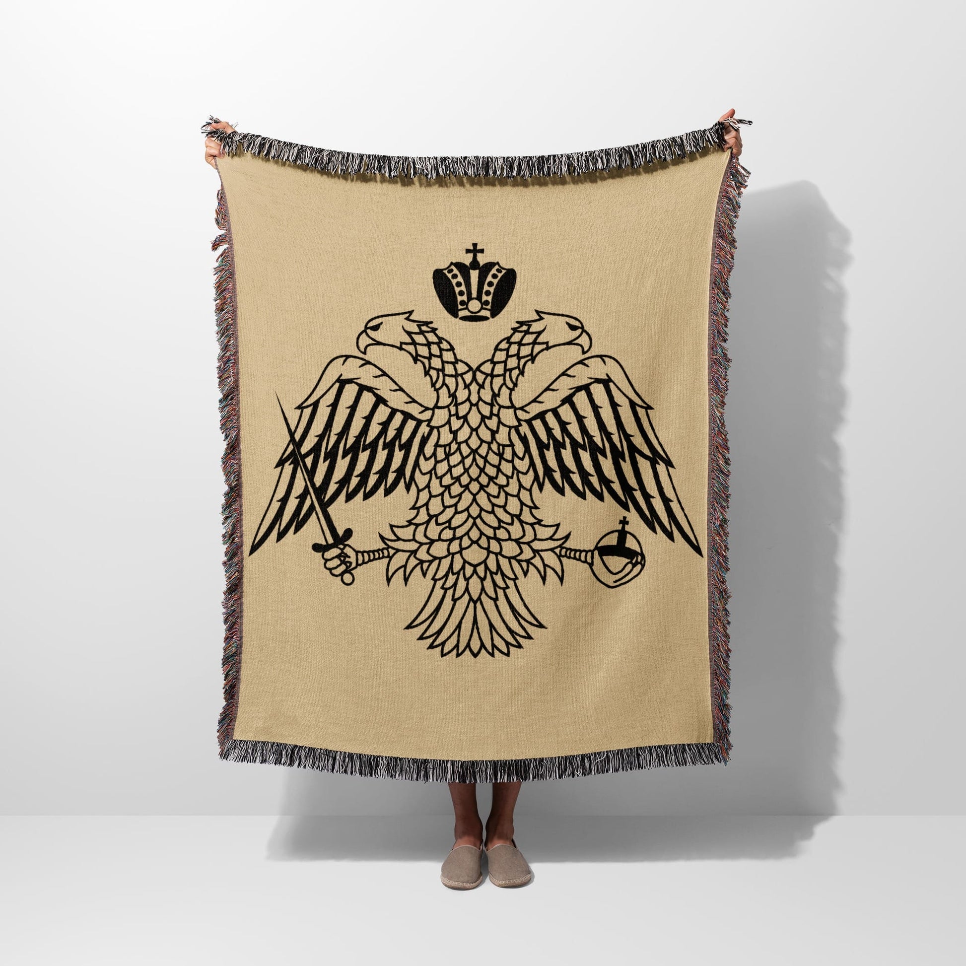 Tapestry with black double-headed eagle, crowns, swords, and tassels.