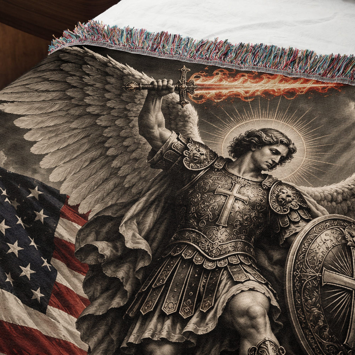 Woven throw blanket featuring an angel with wings and a flaming sword before an American flag.
