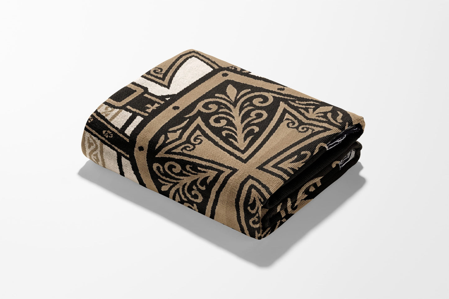 Folded blanket with ornate black and gold pattern on white background.