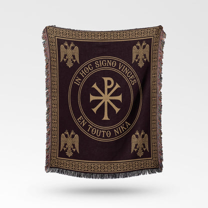Dark brown woven blanket with a gold Chi-Rho symbol and Latin inscription.