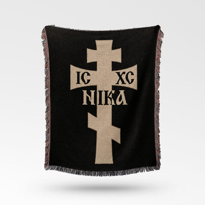 Black woven blanket with a beige cross featuring Greek text "IC XC NIKA".