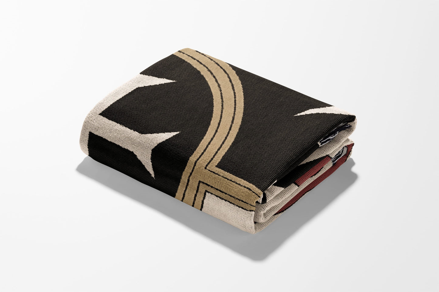 Folded blanket with a black background and beige star pattern.