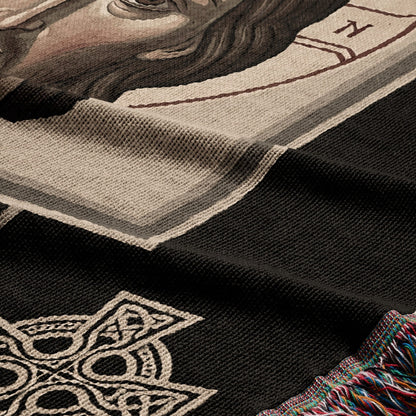 Woven tapestry detail featuring a Celtic knot design and a fragment of a portrait.