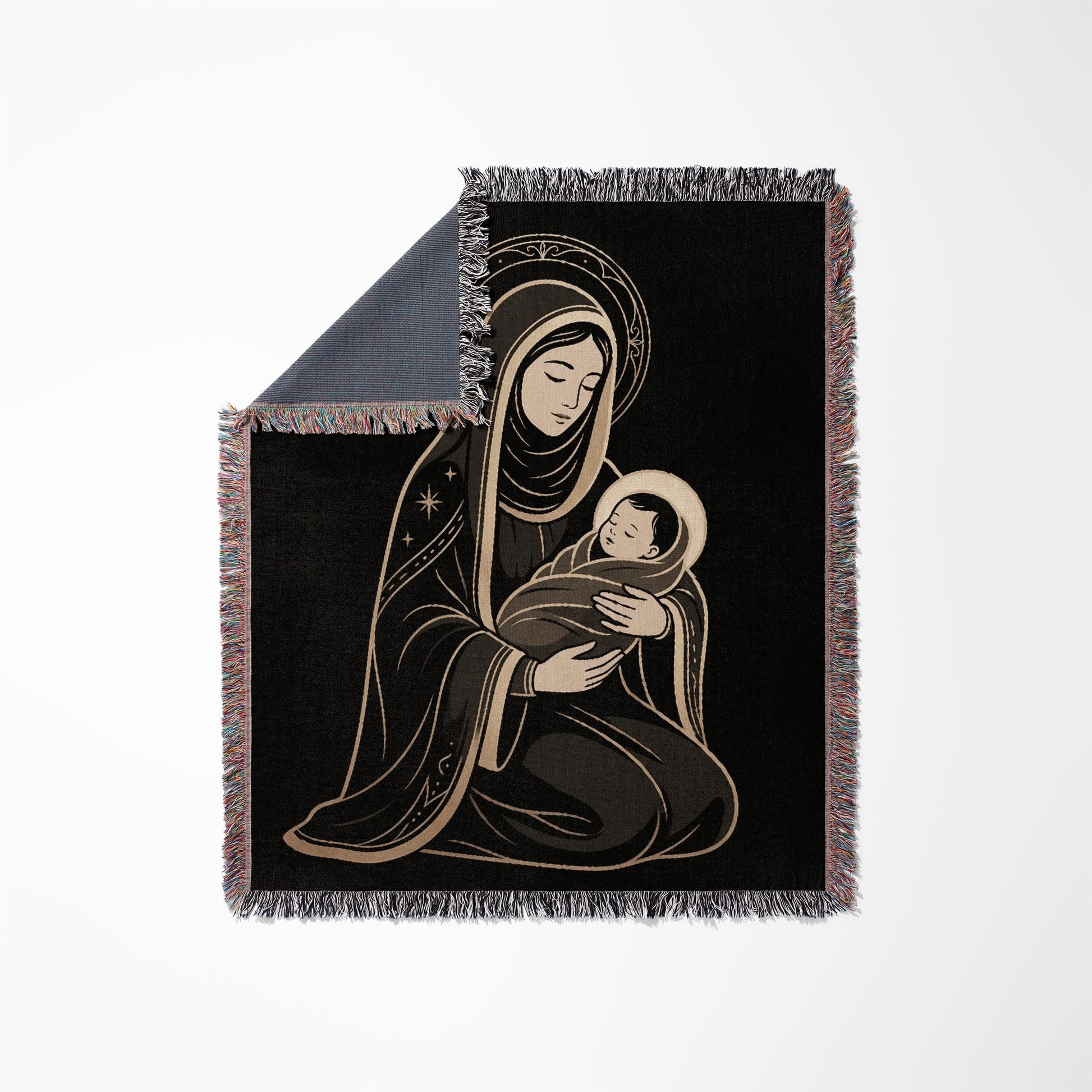 Black woven blanket with fringed edges featuring Mary holding baby Jesus.