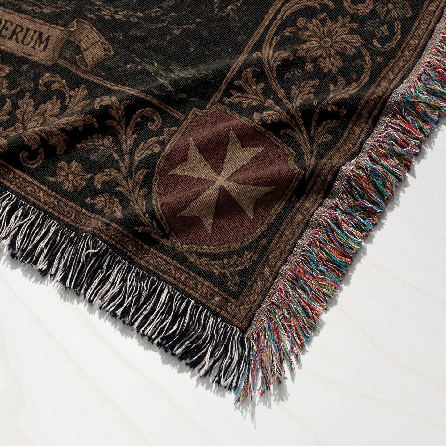 Tapestry blanket with Maltese cross and ornate border, fringed edges.