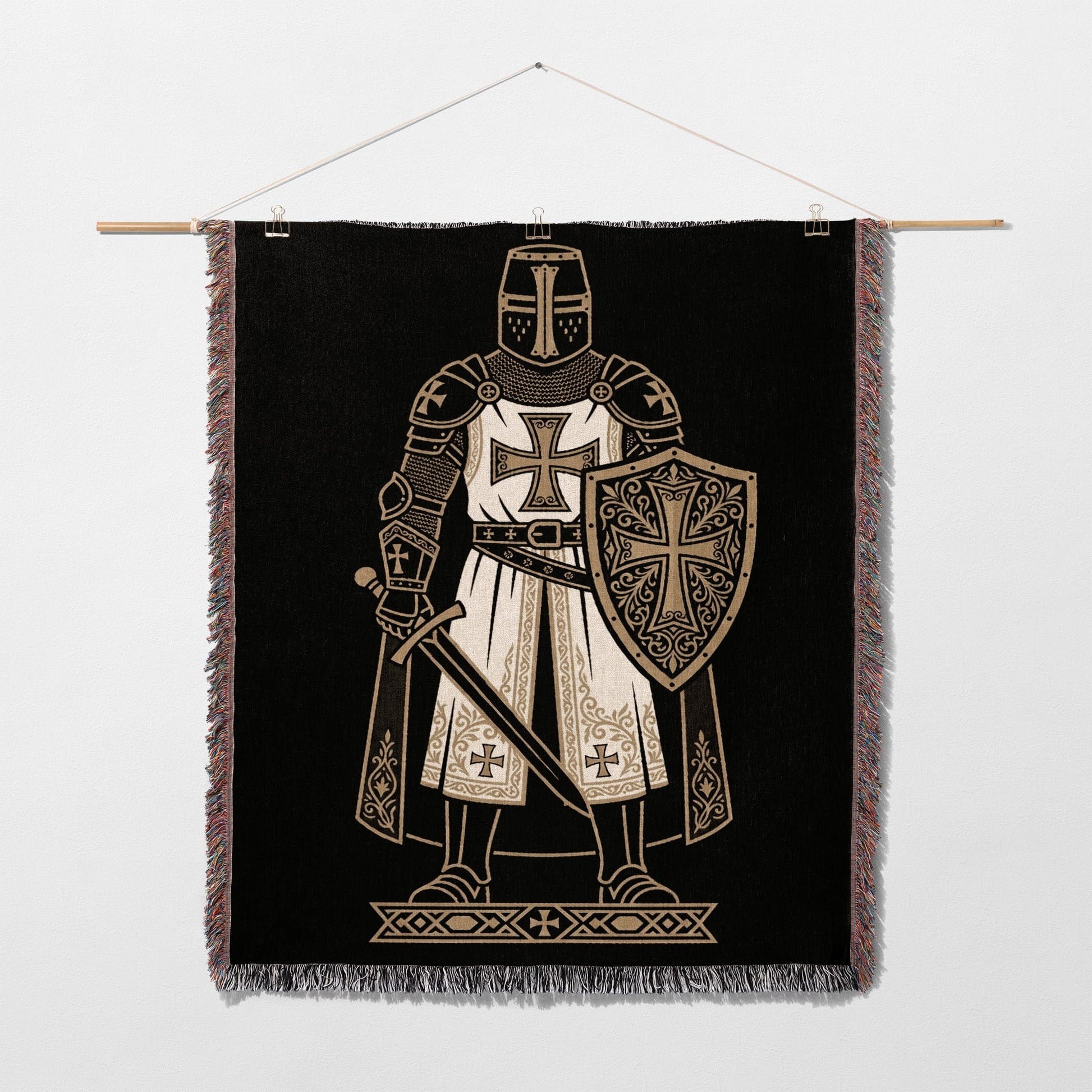 Knight in armor with shield and sword on a black tapestry.
