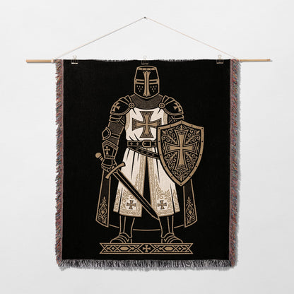 Knight in armor with shield and sword on a black tapestry.