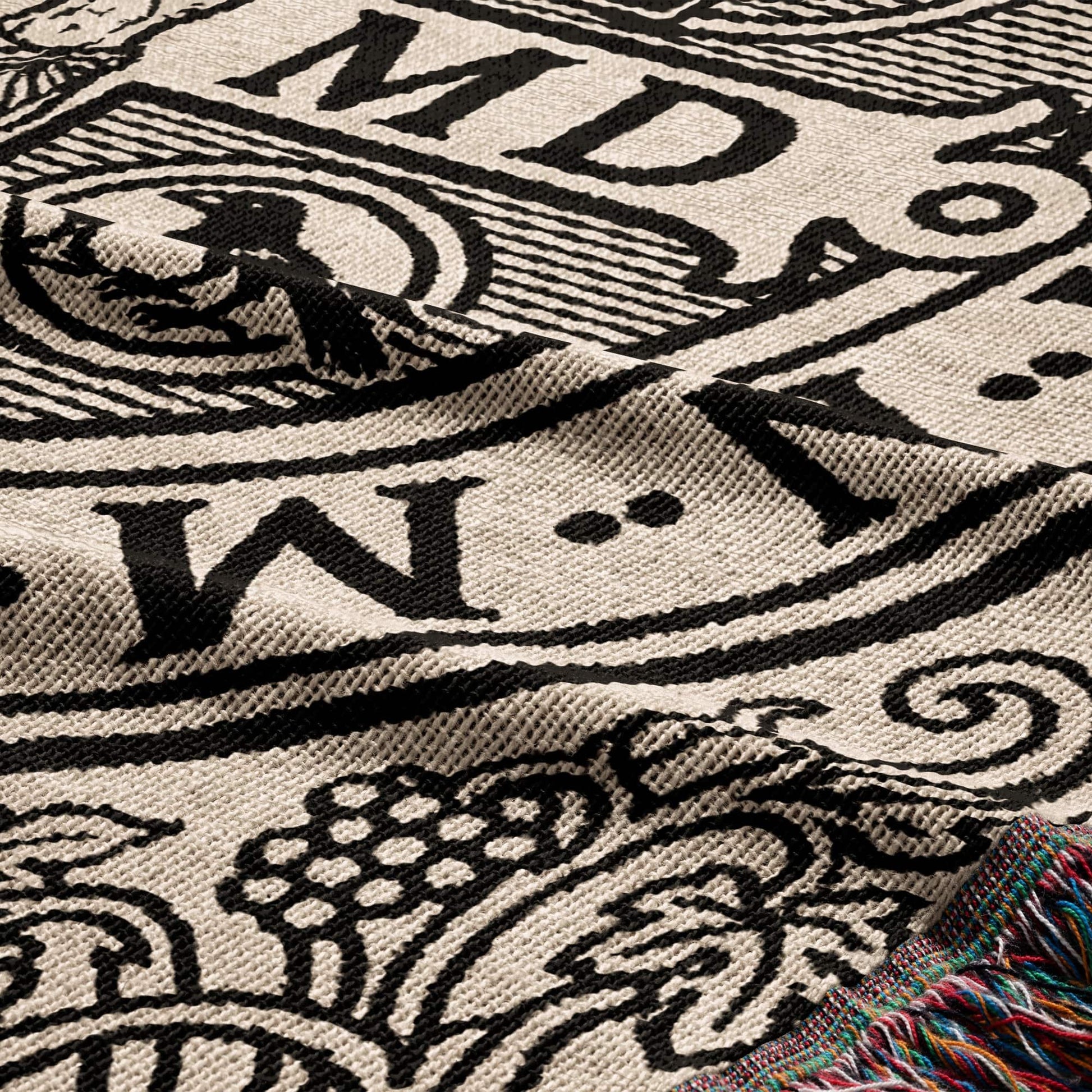 Tapestry with black and white bold lettering and grape vine pattern.
