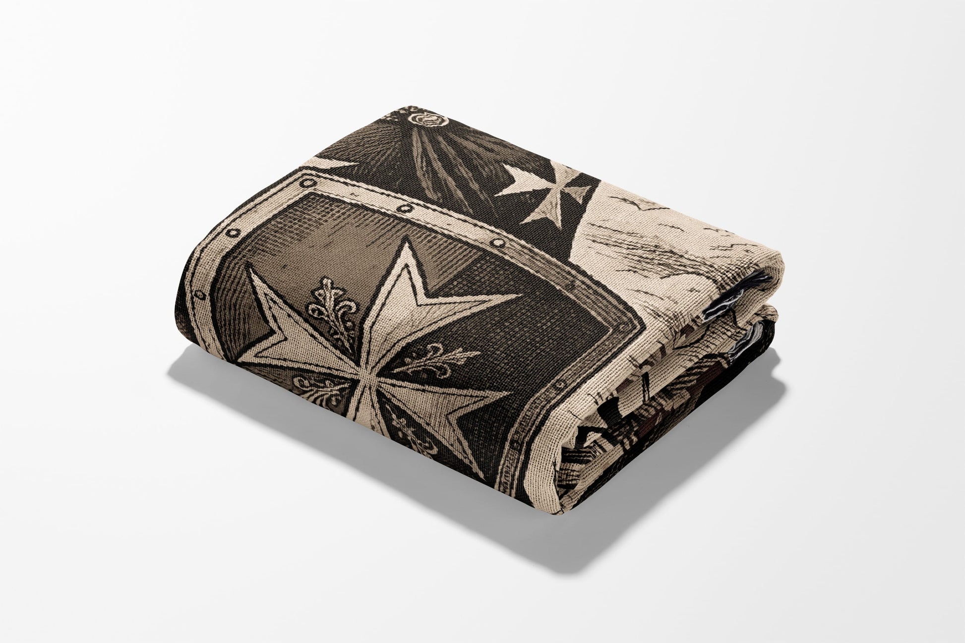 Folded blanket with a vintage maltese cross and shield pattern.
