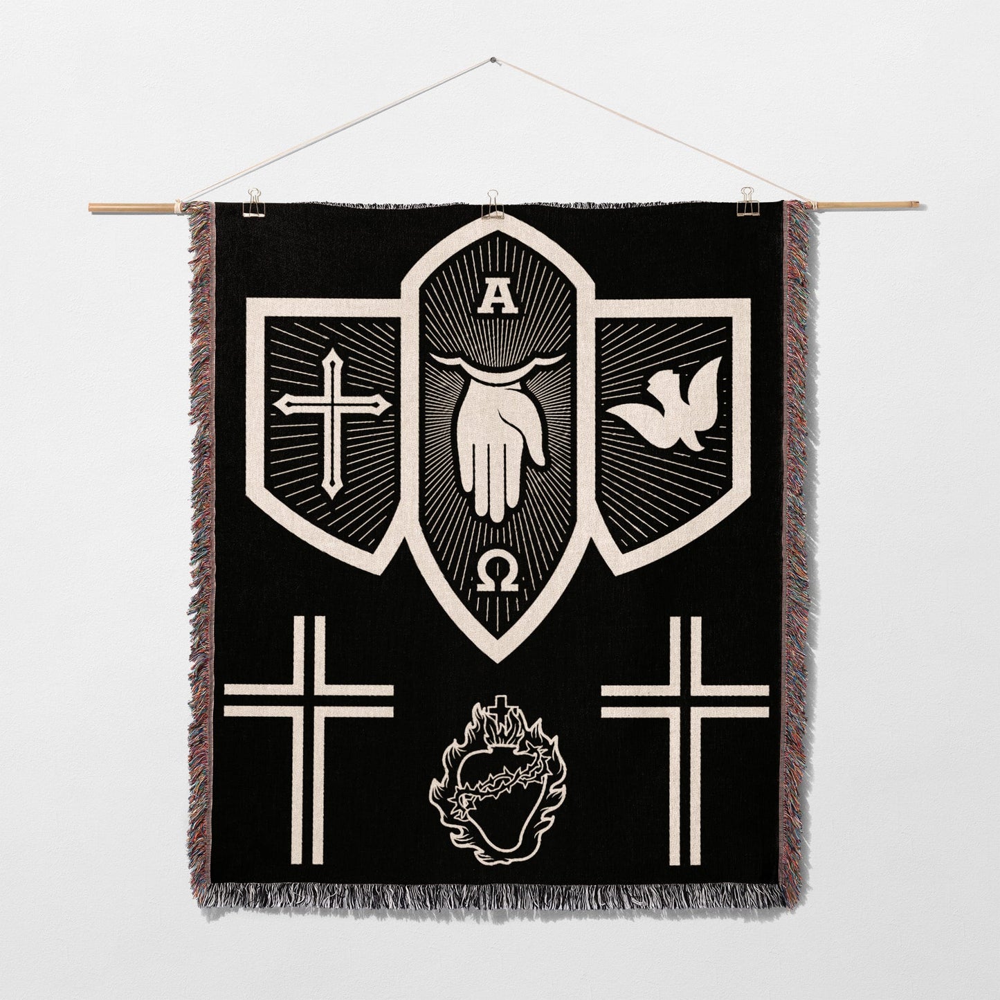 Black tapestry with white religious symbols: hand, dove, crosses, omega, alpha, and heart.