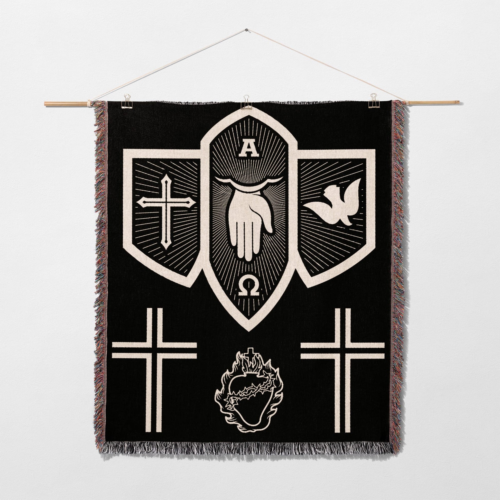 Black tapestry with white religious symbols: hand, dove, crosses, omega, alpha, and heart.