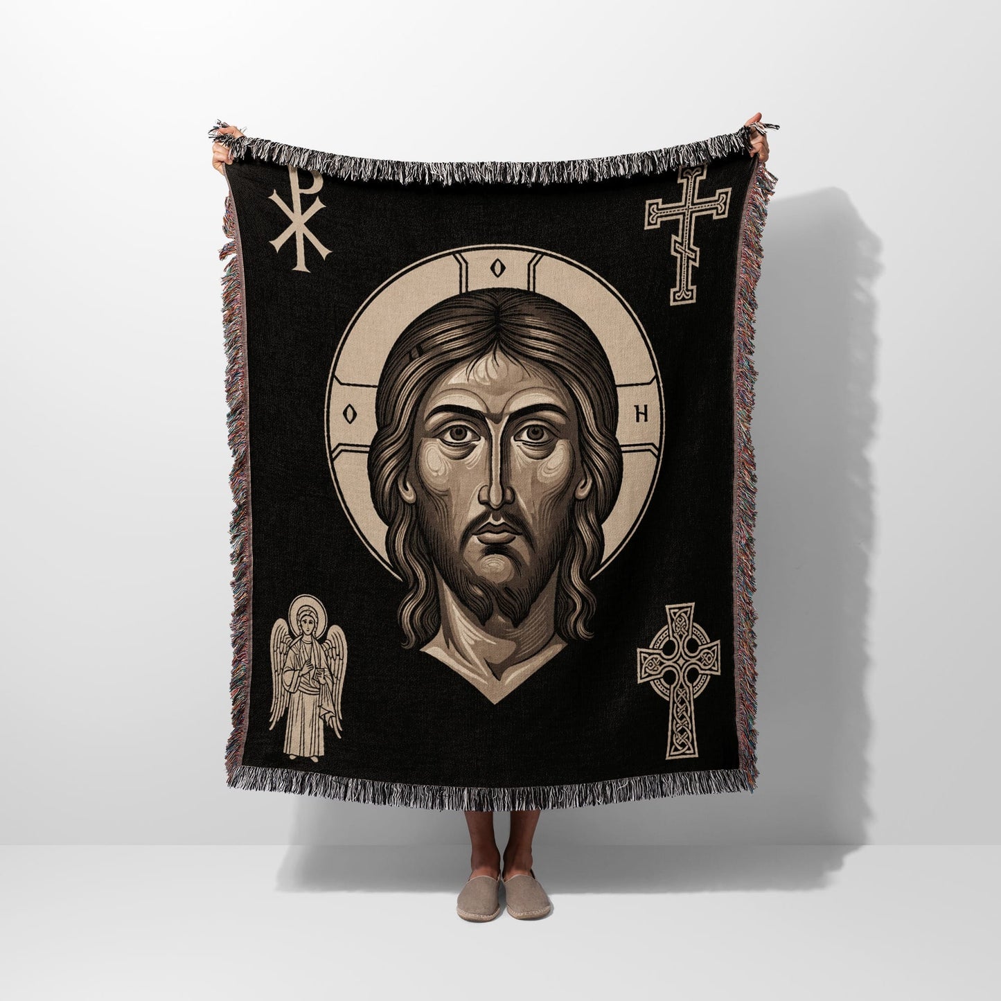 Black throw blanket with embroidered image of Jesus Christ and Celtic knot cross.