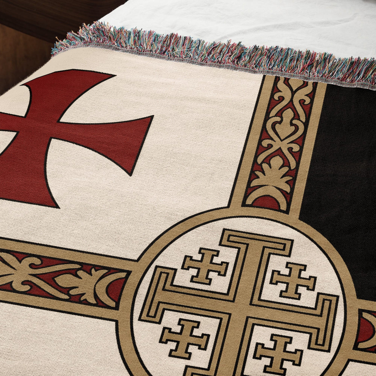 Woven blanket with red Templar cross and Jerusalem cross design.