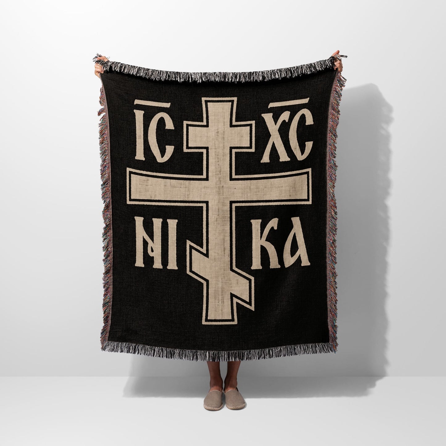 Black throw blanket with large beige Orthodox Christian cross and IC XC NIKA text.