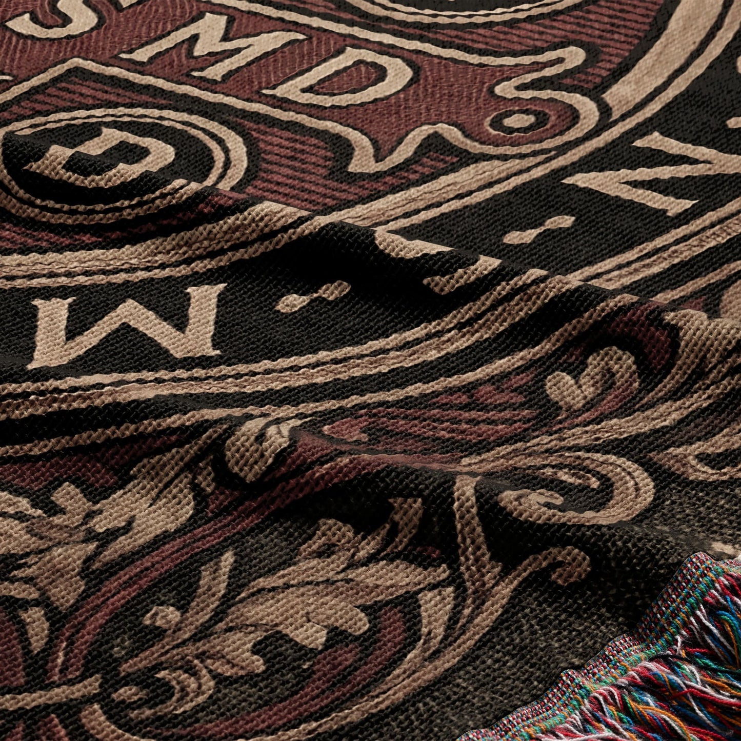 Woven tapestry with ornate scrollwork and letters, in brown, tan, and black.