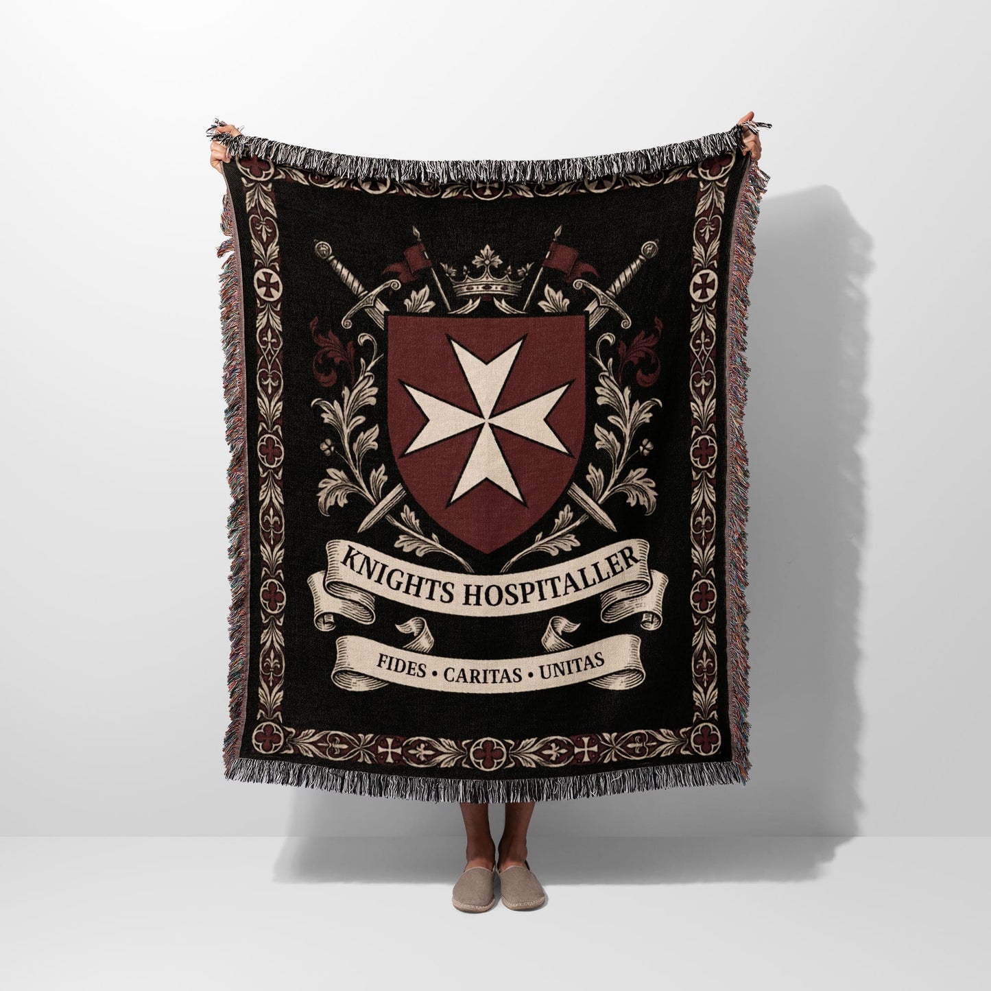 Black tapestry throw with Knights Hospitaller crest, swords, crown, and Latin motto.