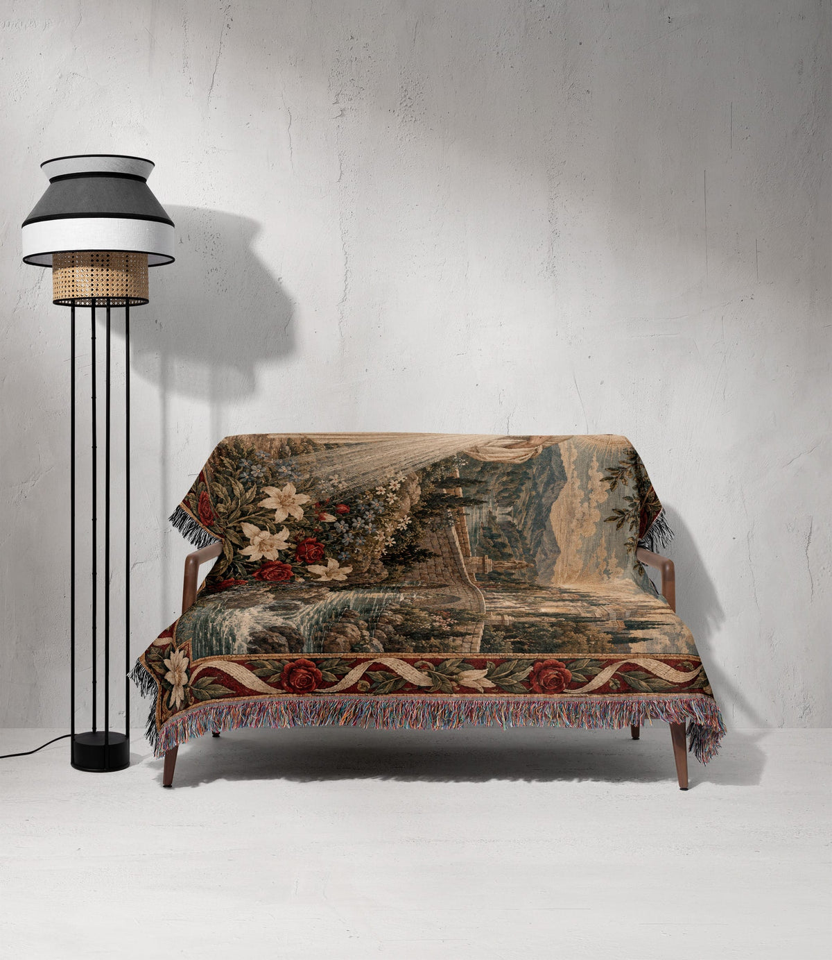 A wooden loveseat is draped with a patterned woven throw blanket next to a modern floor lamp.