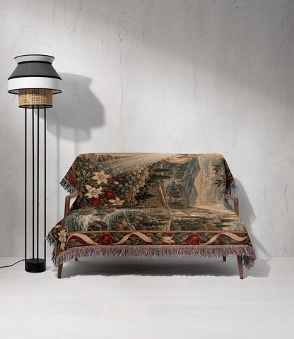 A wooden loveseat is draped with a patterned woven throw blanket next to a modern floor lamp.
