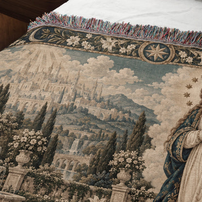 Woven tapestry blanket featuring a medieval castle landscape with ornate floral borders and fringed edges.