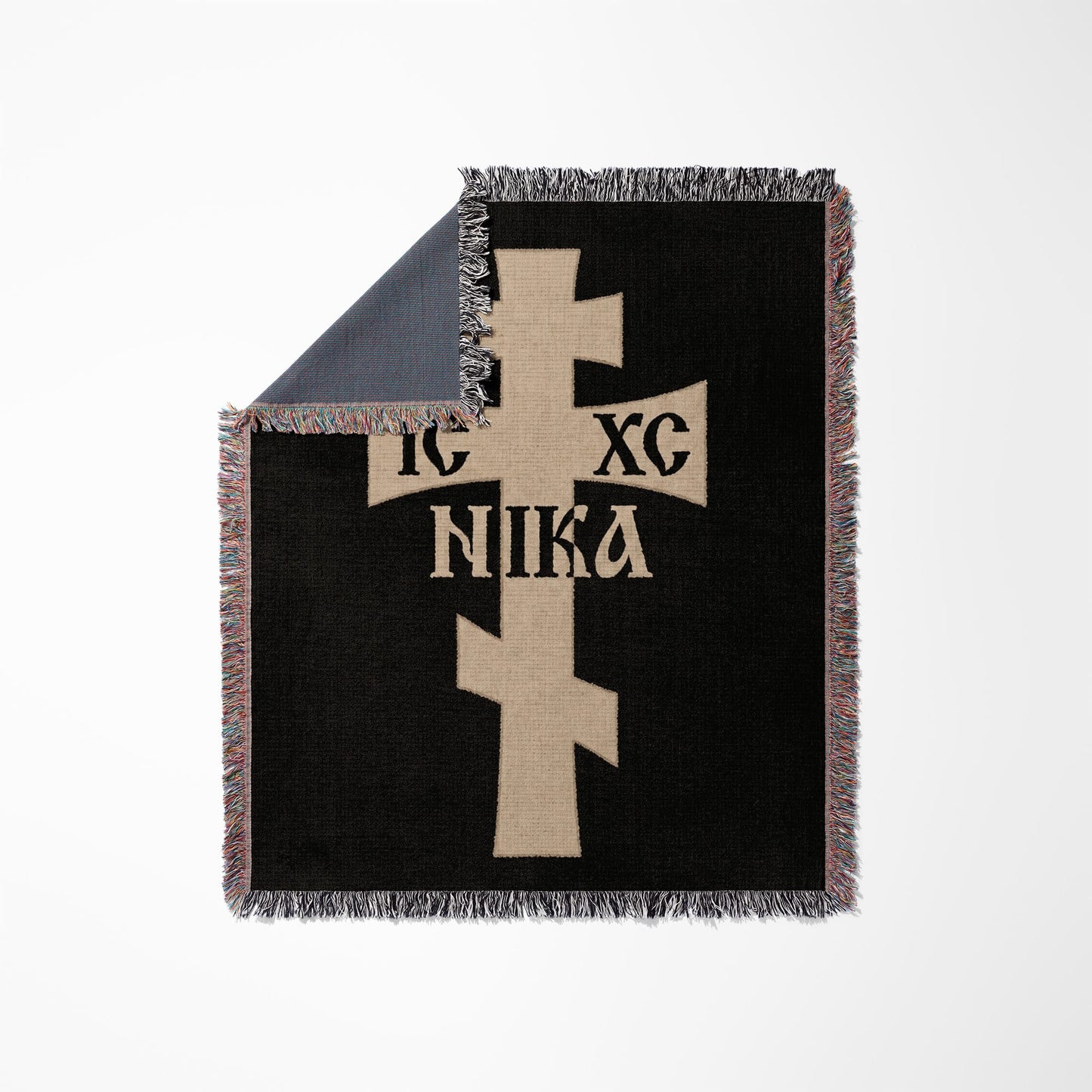 Black blanket with tan Christian cross and Greek text "IC XC NIKA".