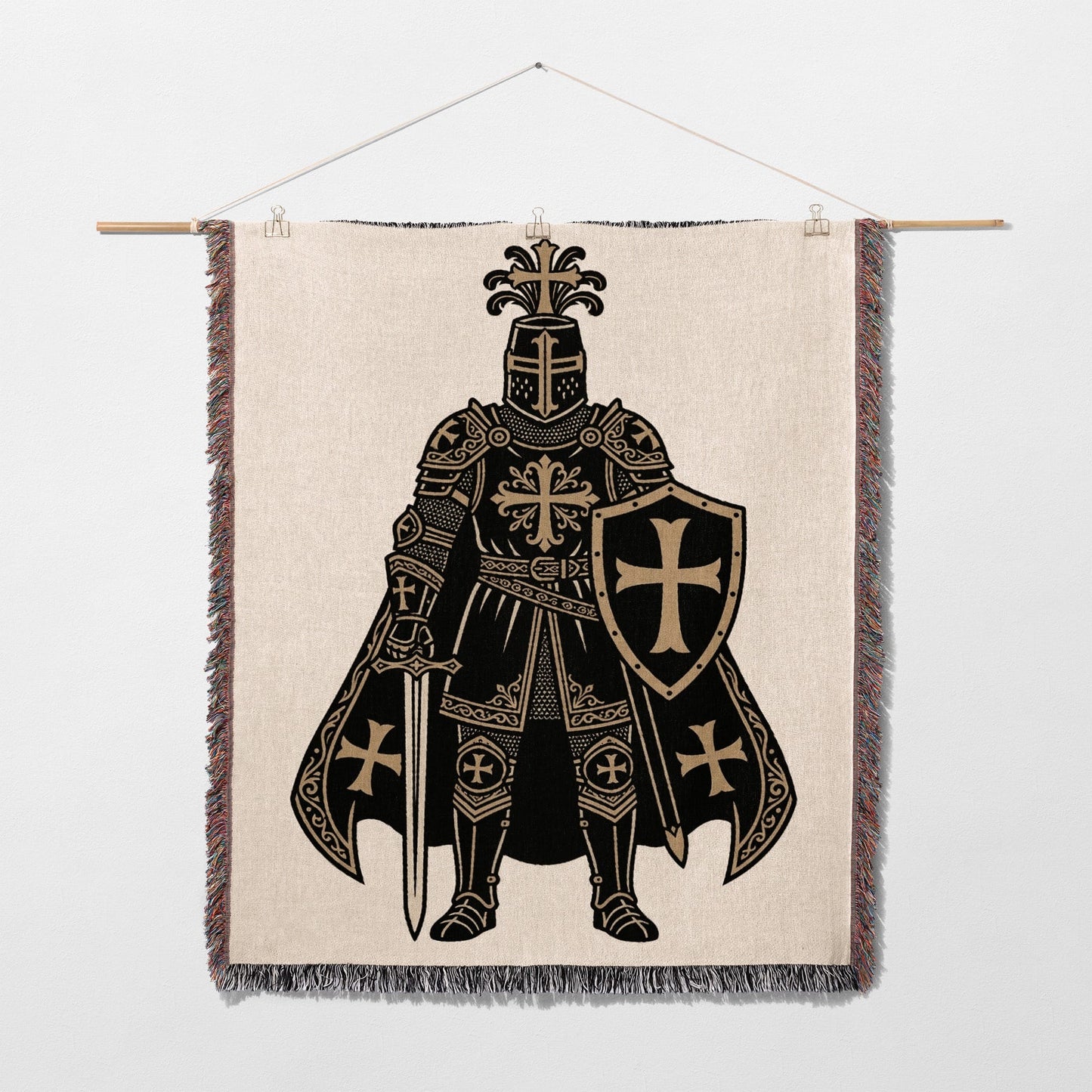 Knight with shield and sword design on a tapestry hanging from a rod.