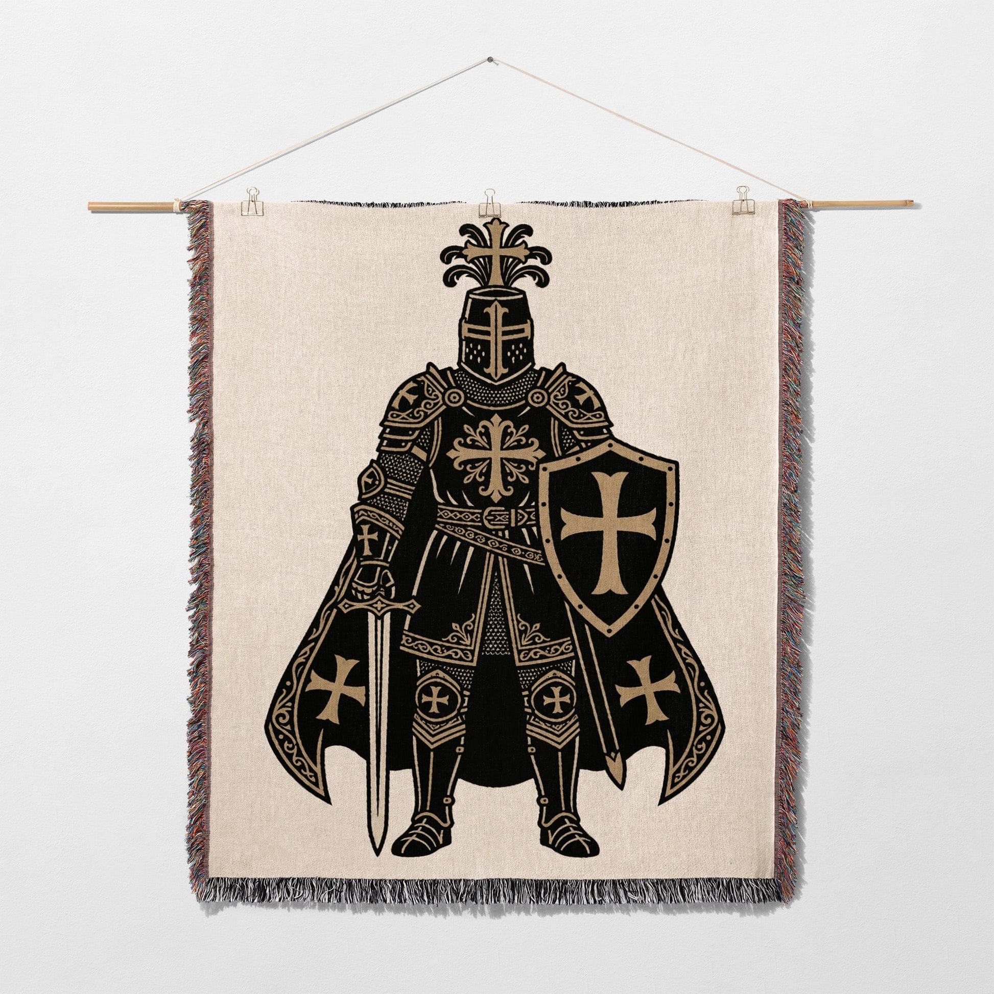 Knight with shield and sword design on a tapestry hanging from a rod.