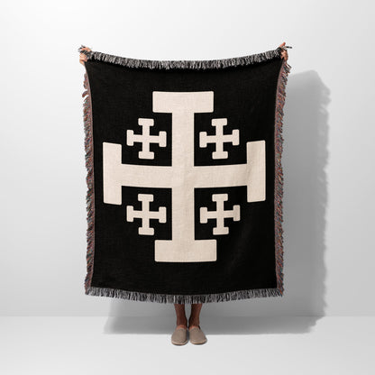 Black throw blanket with large beige Crusader cross and fringed edges.