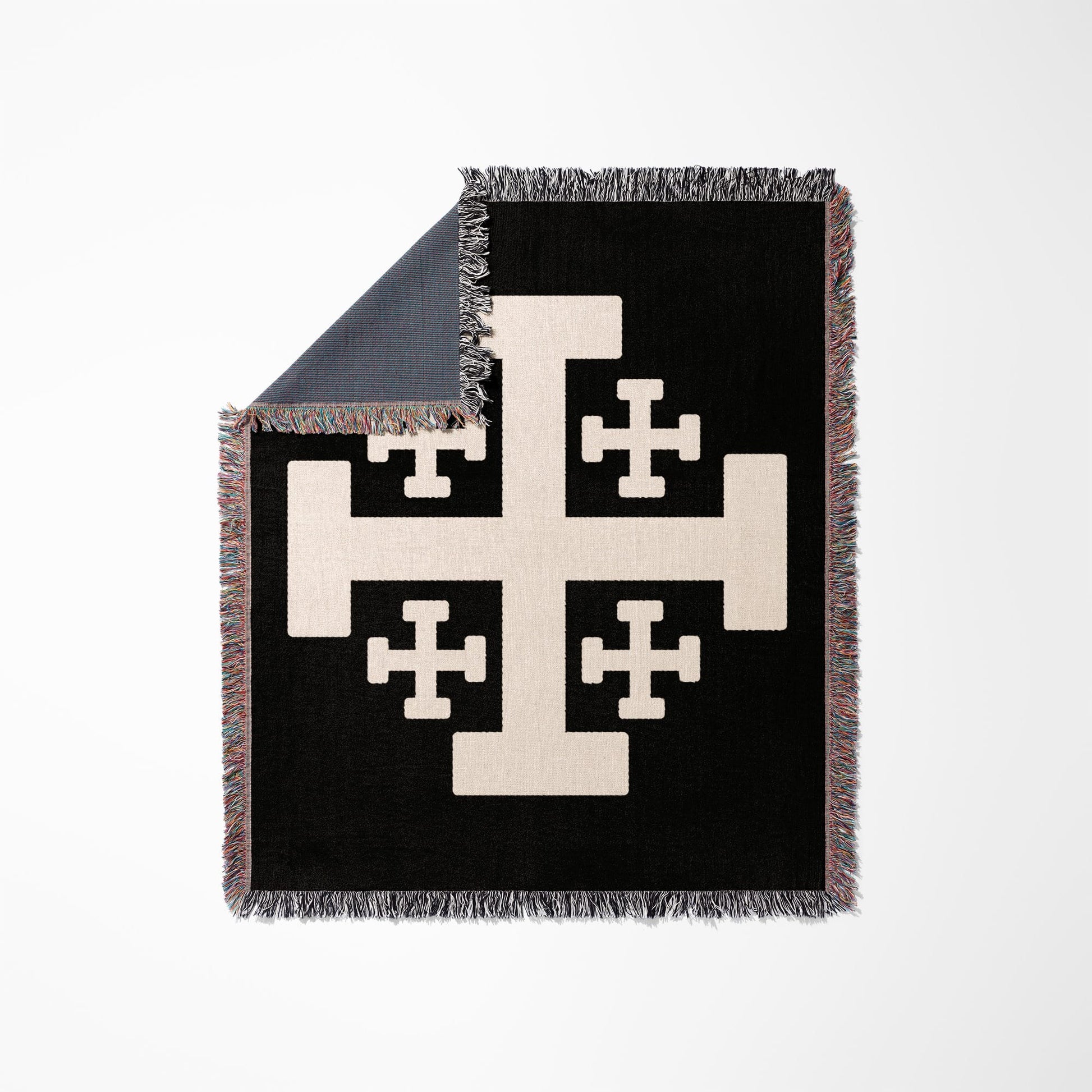 Black throw blanket with a cream-colored Crusader's Cross design and fringed edges.