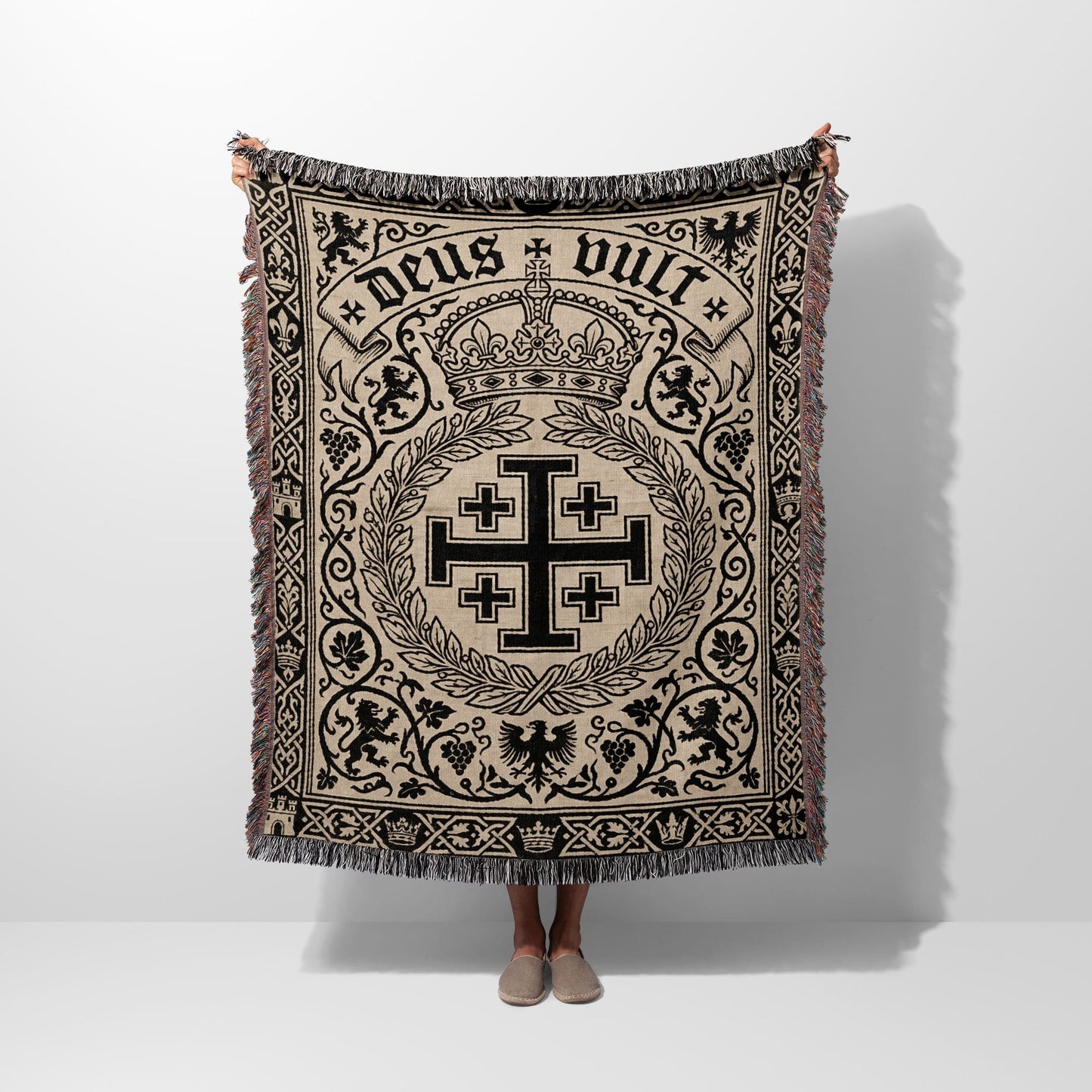 Tapestry blanket with a central Crusader cross, crown, lions, and the text "Deus Vult".