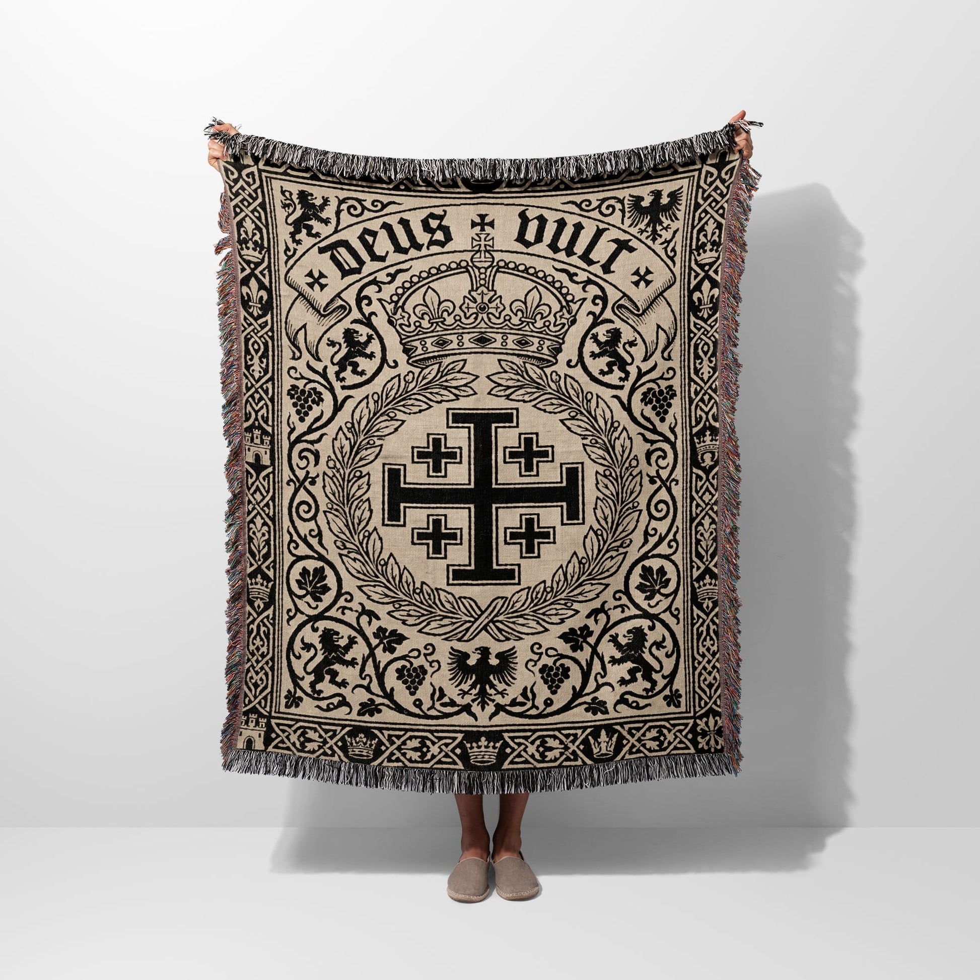 Tapestry blanket with a central Crusader cross, crown, lions, and the text "Deus Vult".